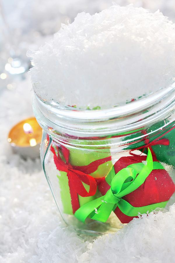 Small Wrapped Gifts In Snow-covered Mason Jar Photograph by Angela Francisca Endress