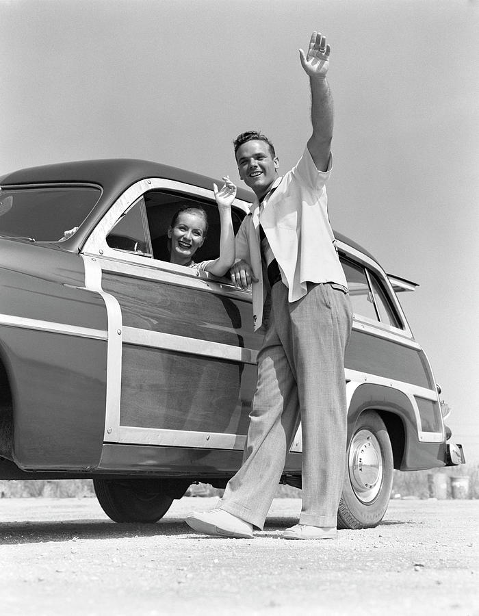 Smiling Couple Waving From A 1949 Photograph by H. Armstrong Roberts