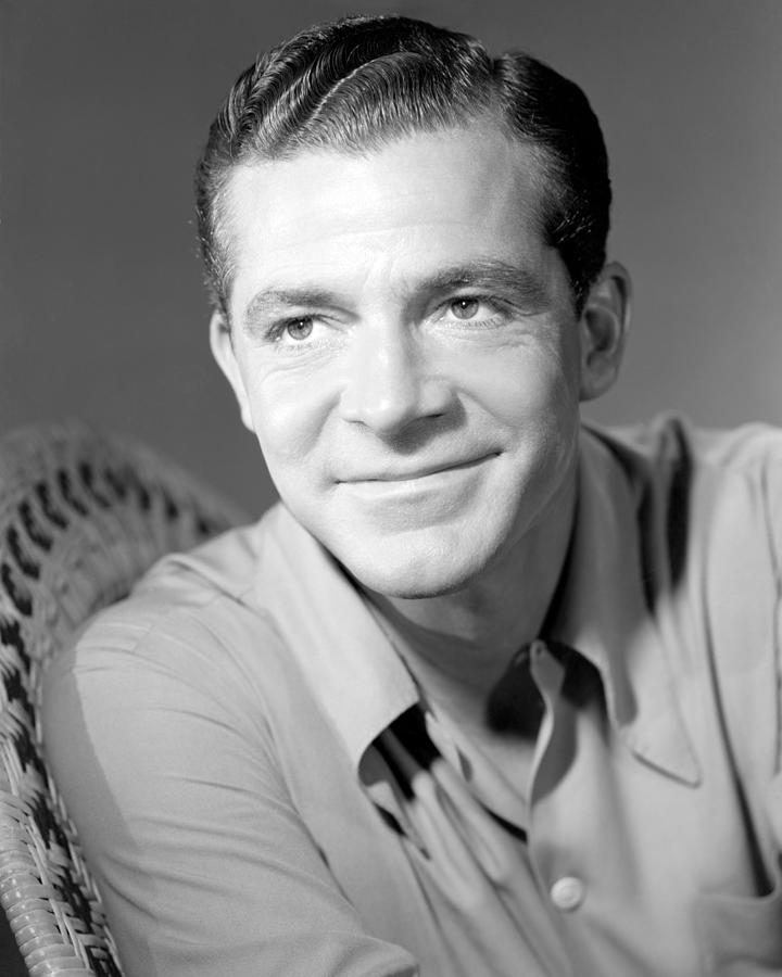 Smiling Dana Andrews Sitting On Wicker Chair Photograph by Globe Photos ...