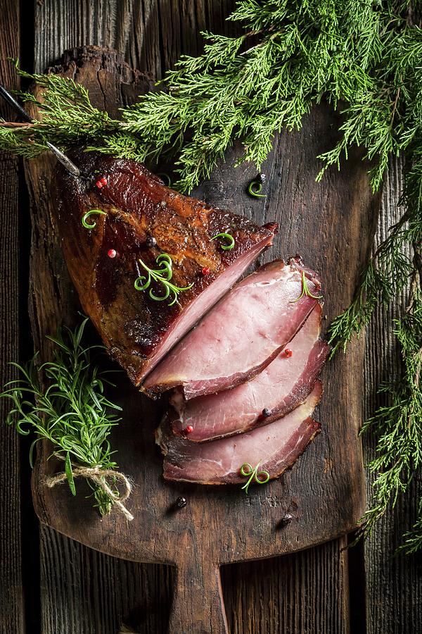 Smoked Ham With Herbs On A Wooden Board Photograph by Shaiith