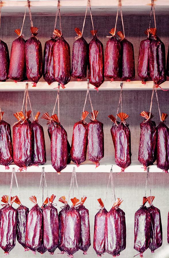 Smoked Hungarian Gyulai Sausages In A Butchers Shop Photograph by Jamie Watson