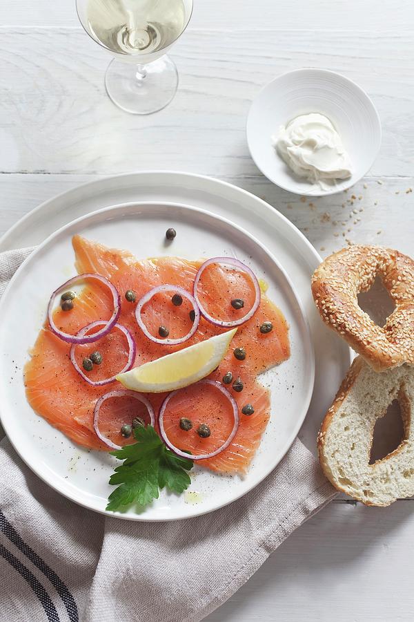 Smoked Salmon With Capers And Onions Served With A Sesame Seed Bagel And Crme Frache Photograph by Stepien, Malgorzata