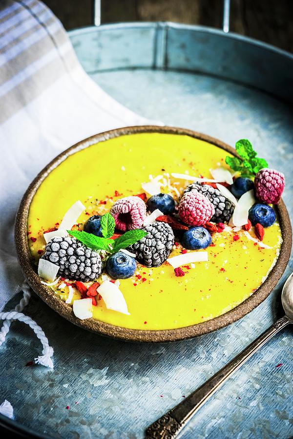 Smoothie Bowl With Mango, Frozen Berries, Grated Coconut And Mint Photograph by Alena Haurylik