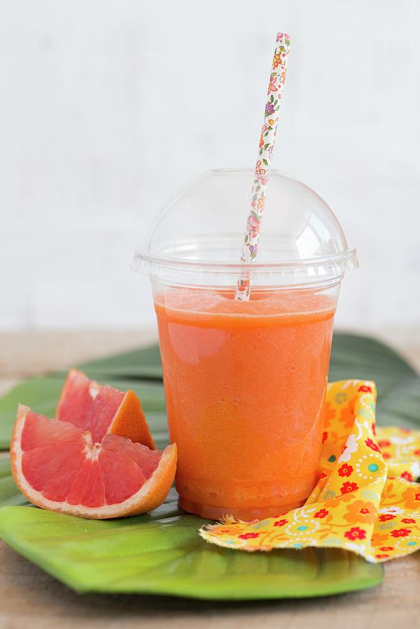 Smoothie With Pink Grapefruit, Carrots, Lemon Juice And Ginger Photograph by Sonia Chatelain