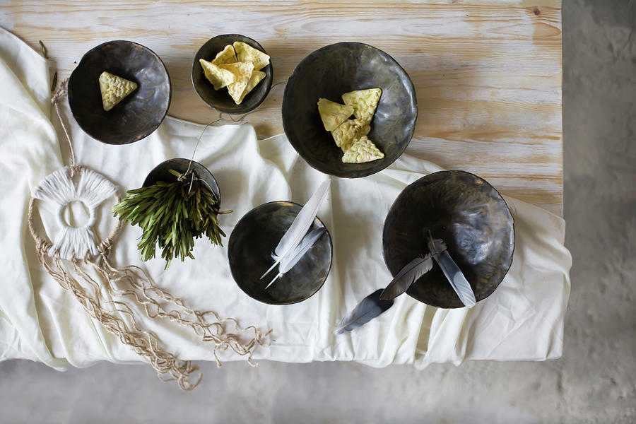 Snacks, Feathers And Herbs In Black Bowls And Dreamcatcher Photograph by Alicja Koll