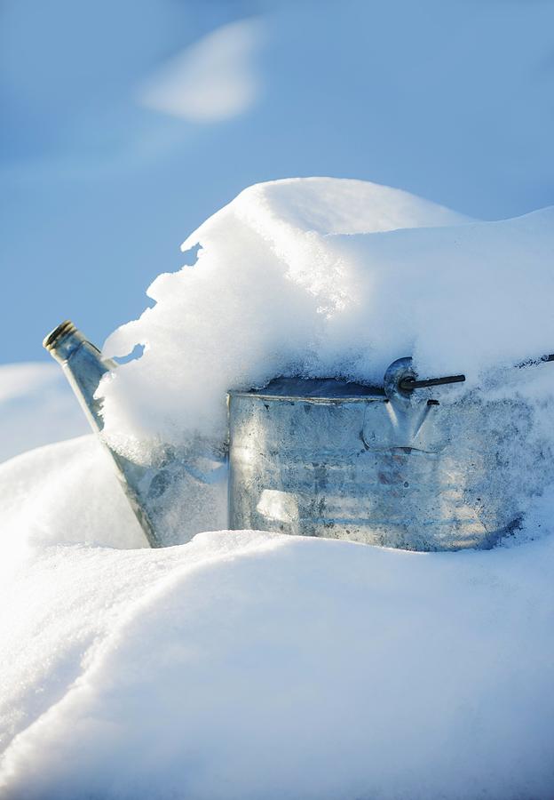 Snow Covering A Metal Watering Can Photograph by Colin Cooke