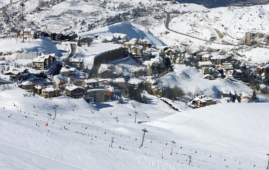 Snow Covers Houses As People Ski Photograph by Aziz Taher - Fine Art ...