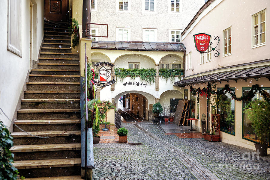 Snow on the Cobblestone in Salzburg Photograph by John Rizzuto