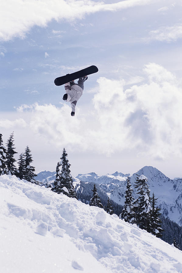 Snowboarder Performing Jump, Low Angle Photograph by Chase Jarvis