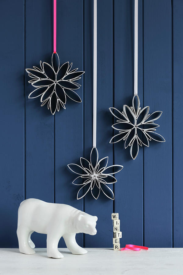Snowflakes Handmade From Toilet Roll Tubes Against Blue Board Wall Photograph by Thordis Rggeberg