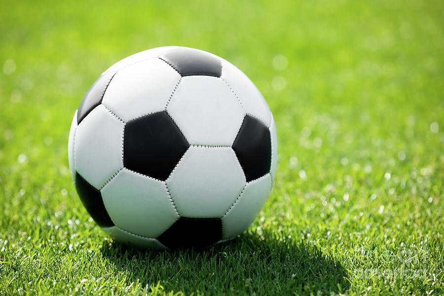 Soccer Ball on a Soccer Field. Green Grass Football Pitch Photograph by