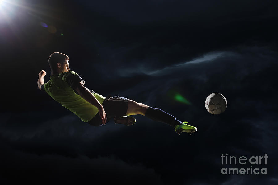 Soccer Player Kicking The Ball Photograph by Stanislaw Pytel