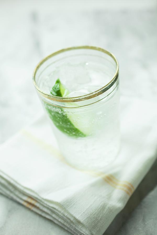 Soda Water With Lime And Ice Cubes Photograph by Rene Comet