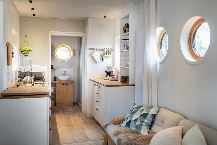 Sofa, Kitchen And Entrance To Bathroom In Tiny House Photograph by Pia Simon