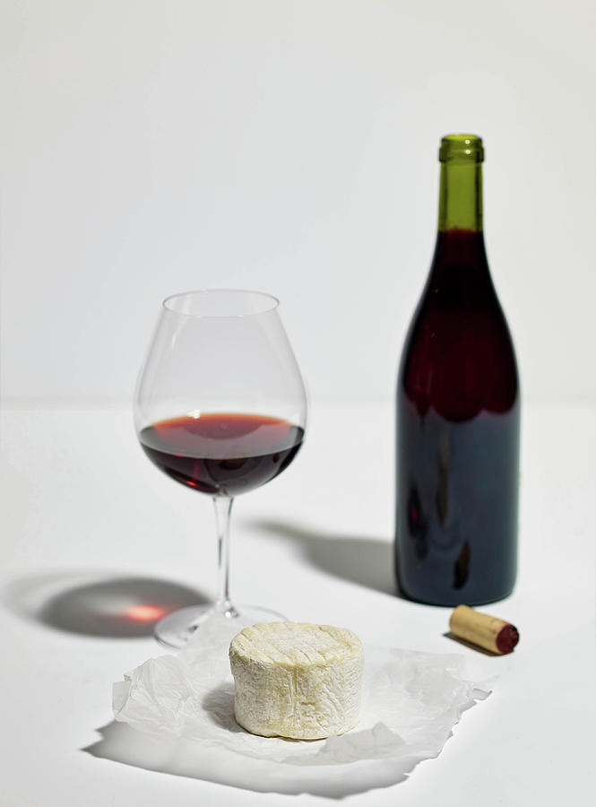 Soft Cheese, A Glass Of Red Wine, A Bottle Of Red Wine And A Cork Photograph by Herbert Lehmann