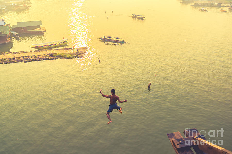 Strength Photograph - Soft Focus Man Jumping Over Fall River by Eakkaluktemwanich Strength Photograph - Soft Focus Man Jumping Over Fall River by Eakkaluktemwanich
