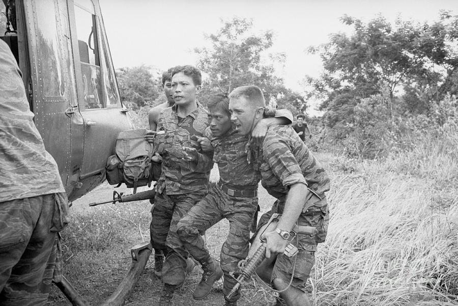 Soldier Being Helped To Helicopter Photograph by Bettmann