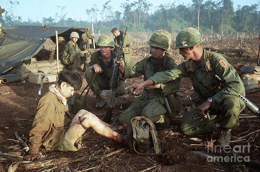 Soldier Points At Seated Vietcong Photograph by Bettmann