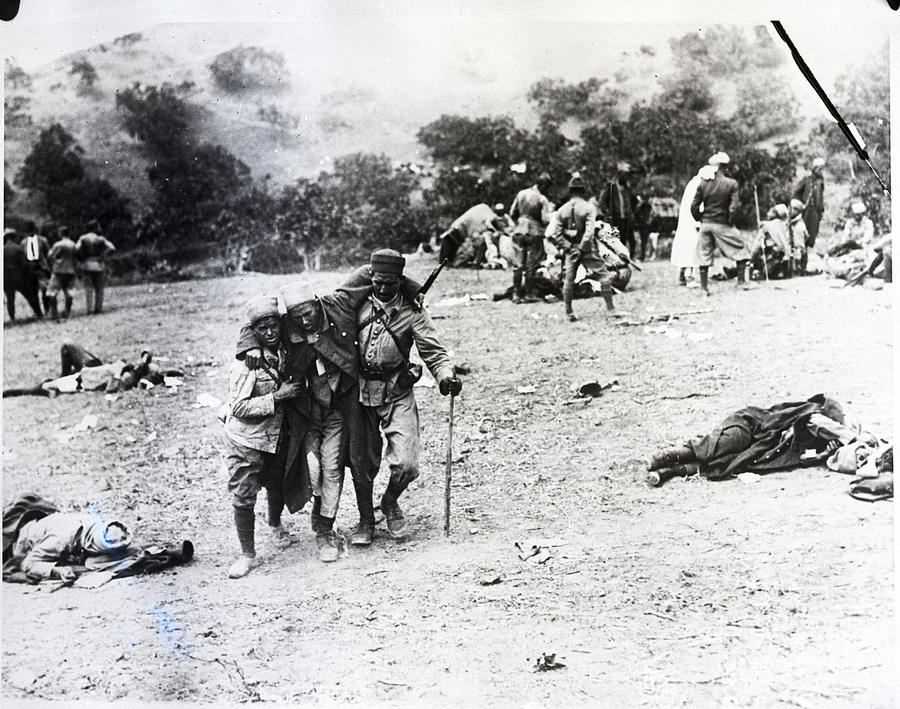 Soldiers Carry Wounded Algerian Rifleman Photograph by Bettmann