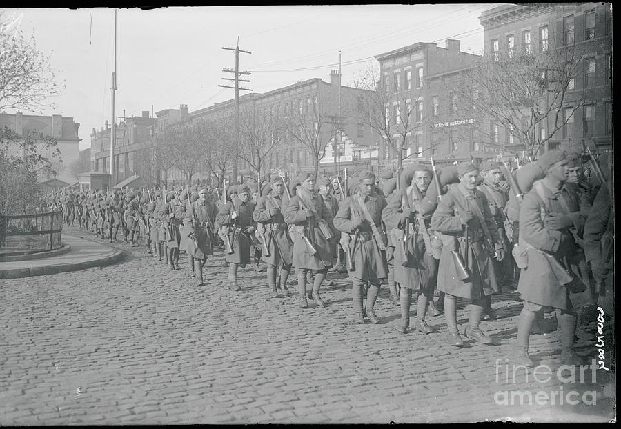 Soldiers Marching In Street Photograph by Bettmann
