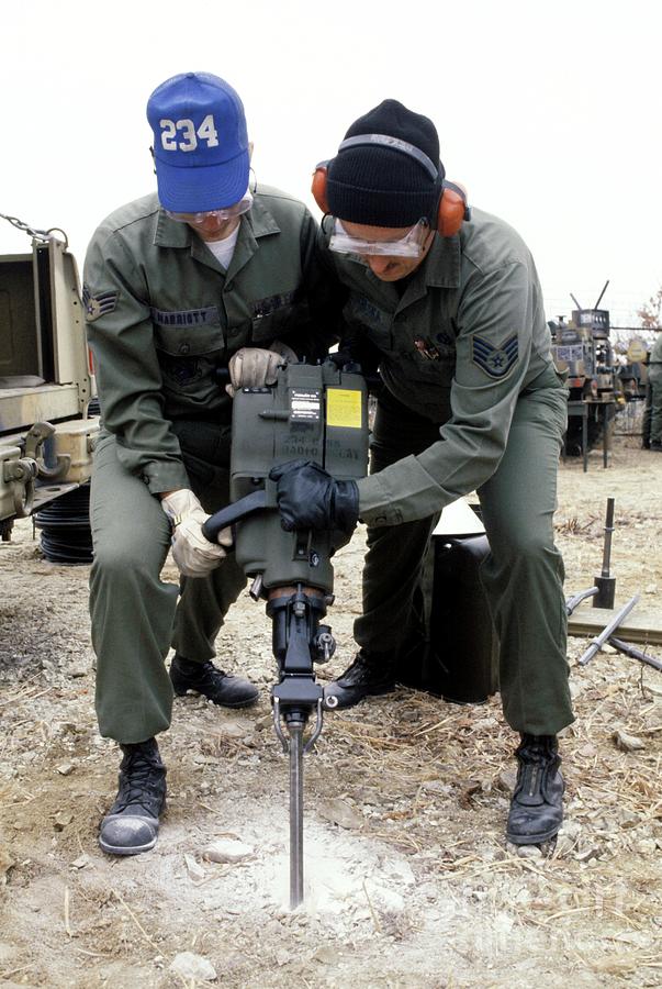 Soldiers Using A Pneumatic Drill Photograph by Us Air Force/science Photo Library