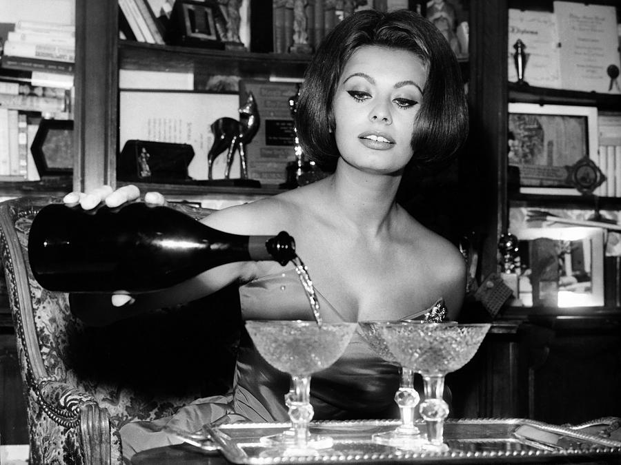 1963 Photograph - Sophia Loren Pouring Champagne by Globe Photos