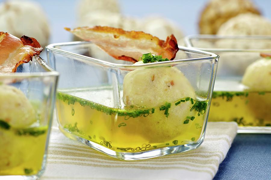 Soup With Bacon And Semolina Dumplings In Small Glass Bowls Photograph by Herbert Lehmann