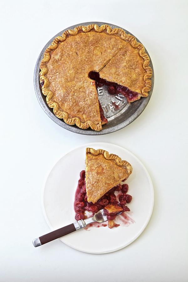 Sour Cherry Pie Whole And Sliced On A White Plate Photograph by Andre Baranowski