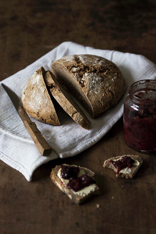 Sourdough Bread With Homemade Jam On A Rustic Wooden Surface Photograph by Malgorzata Laniak