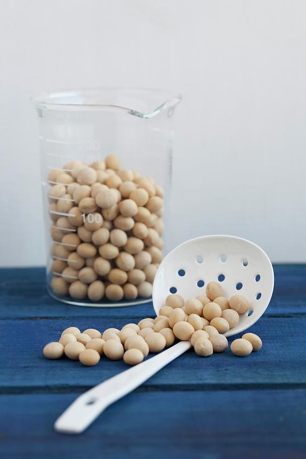 Soy Beans In A Measuring Jug And On A Draining Spoon Photograph by Schindler, Martina
