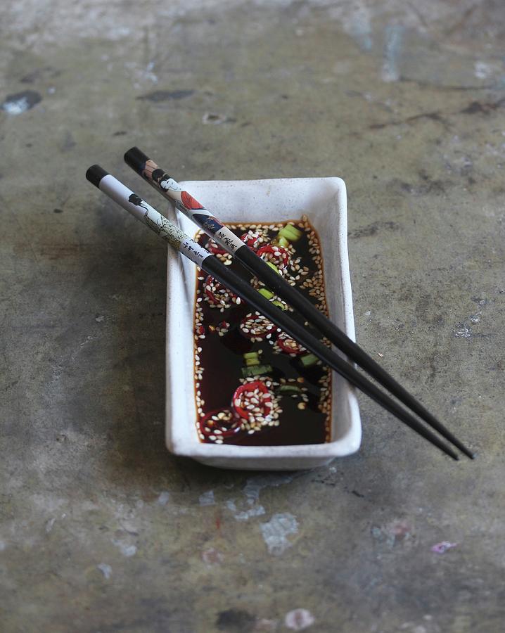 Soy Sauce With Chilies And Sesame Seeds In A Rectangular Bowl japan Photograph by Milly Kay