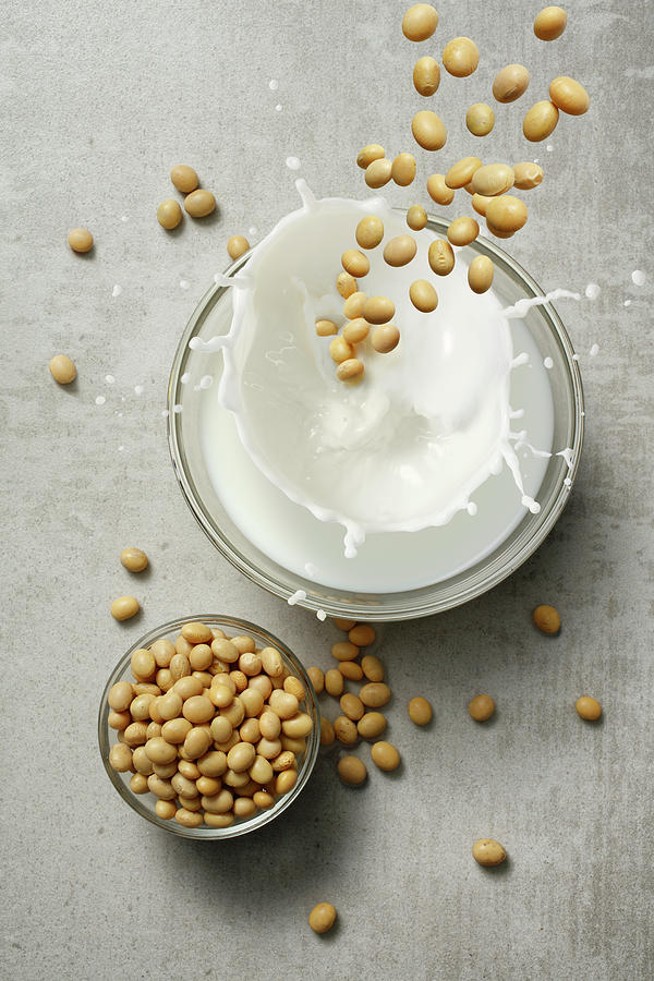 Soya Beans Falling Into A Glass Of Milk Photograph by Petr Gross