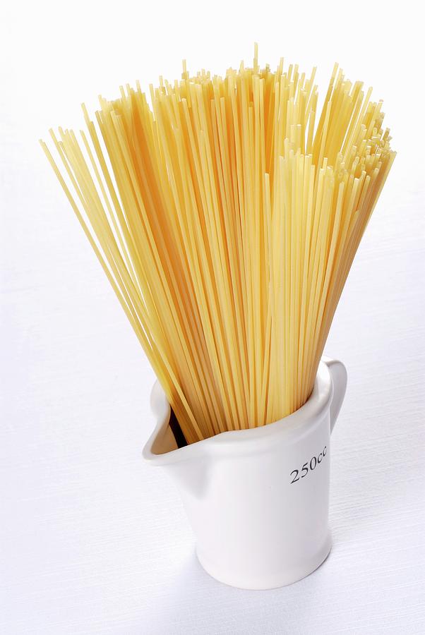 Spaghetti In A Measuring Cup Photograph by Franco Pizzochero
