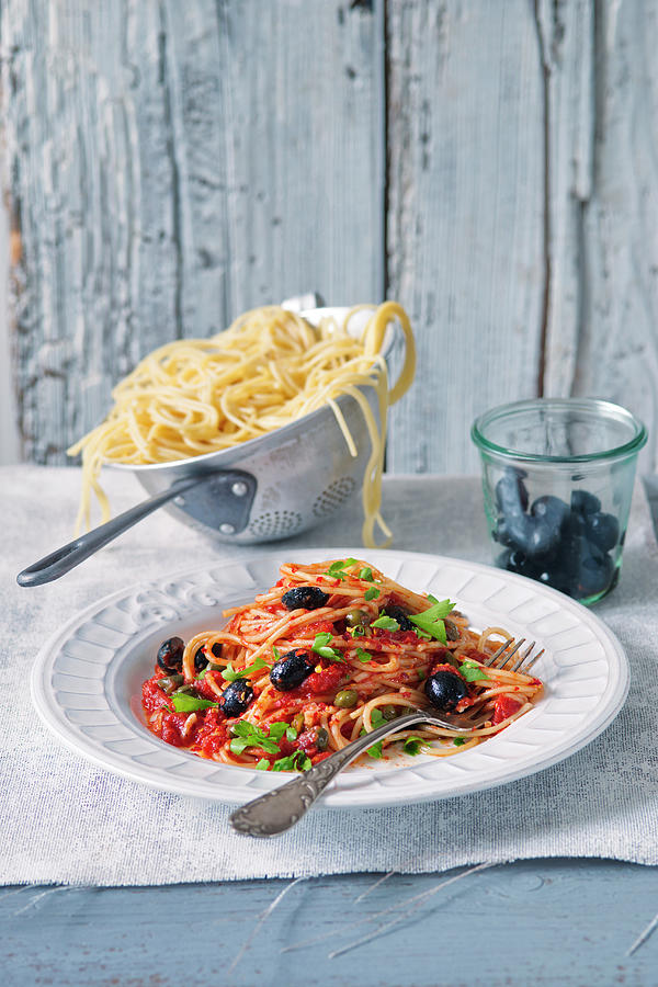 Spaghetti Puttanesca With Tomatoes And Olives Photograph by Alena Hrbkov