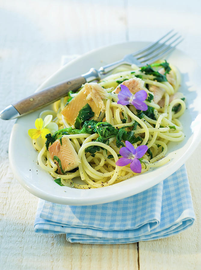 Spaghetti With Smoked Trout Fillets And Edible Flowers Photograph by Andreas Thumm