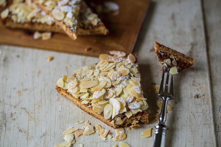 Spanish Almond Cake On A Light Wooden Surface Photograph by Nicole Godt