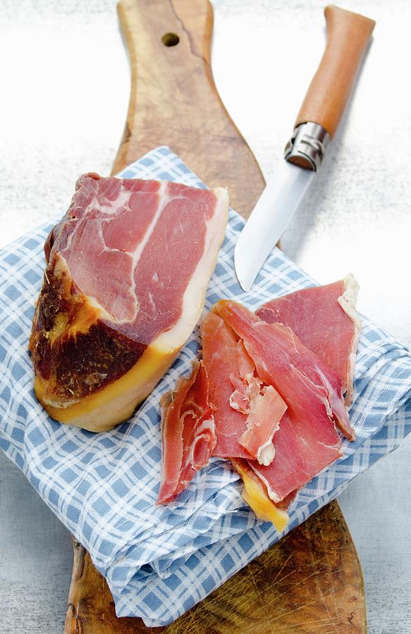 Spanish Serrano Ham, A Large Piece And Slices Photograph by Watson, Jamie
