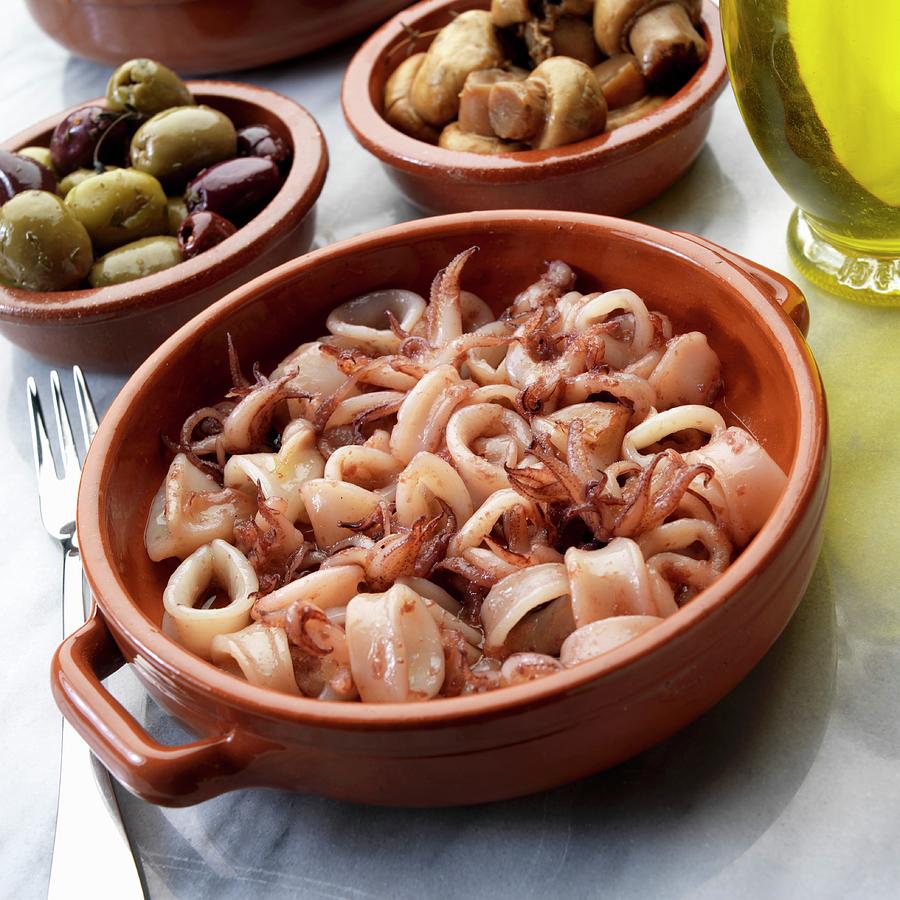 Spanish Tapas: Pan-fried Calamari With Olives And Mushrooms Photograph by Paul Poplis