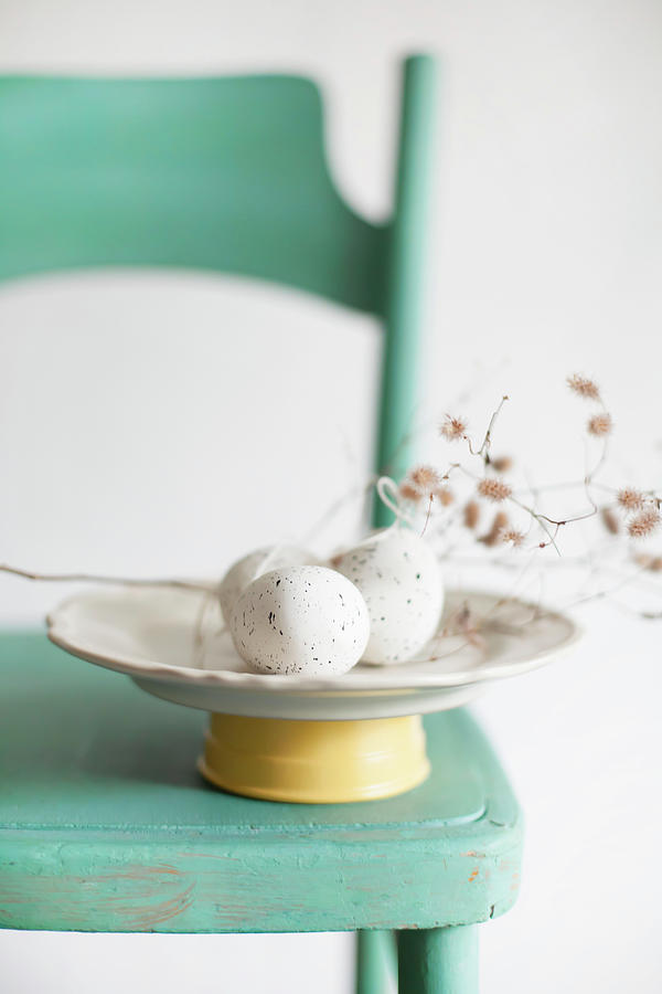 Speckled Eggs And Catkins On Plate On Green Chair Photograph by Alicja Koll