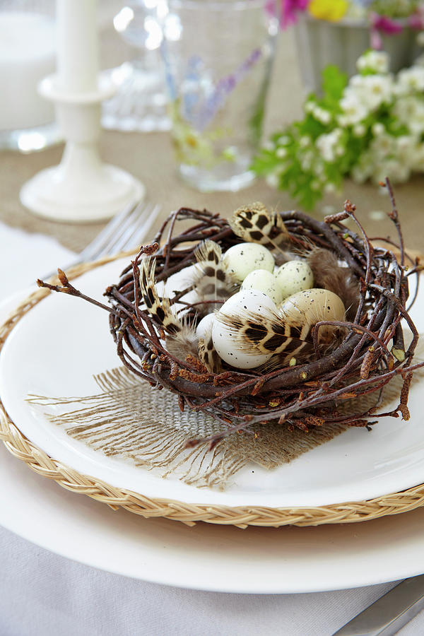 Speckled Eggs And Feathers In Easter Nest Decorating Table Photograph by Simon Scarboro