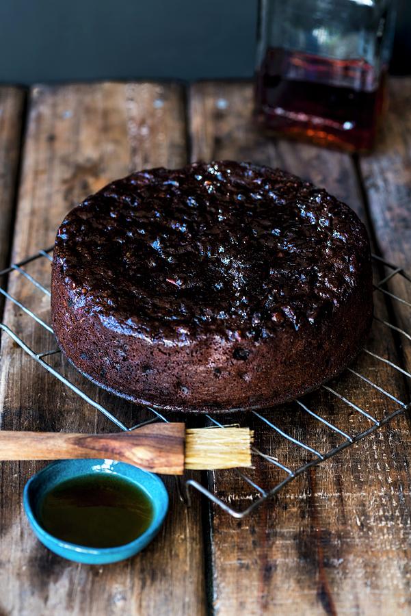 Spelt And Amaretto Fruit Cake On A Cooling Rack Photograph by Hein Van Tonder