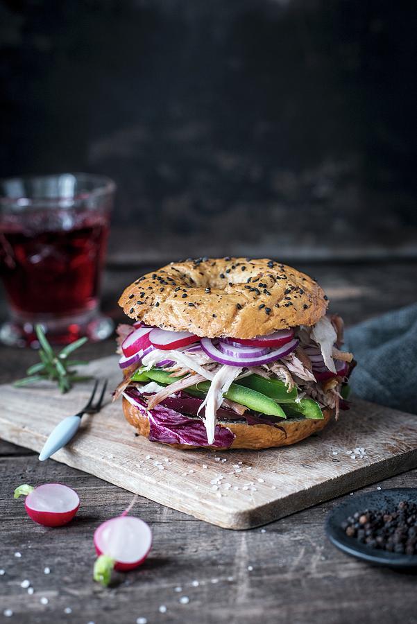 Spelt Bagel With Black Sesame, Radishes, Green Peppers, Red Onion And Pulled Chicken Photograph by Carolin Strothe