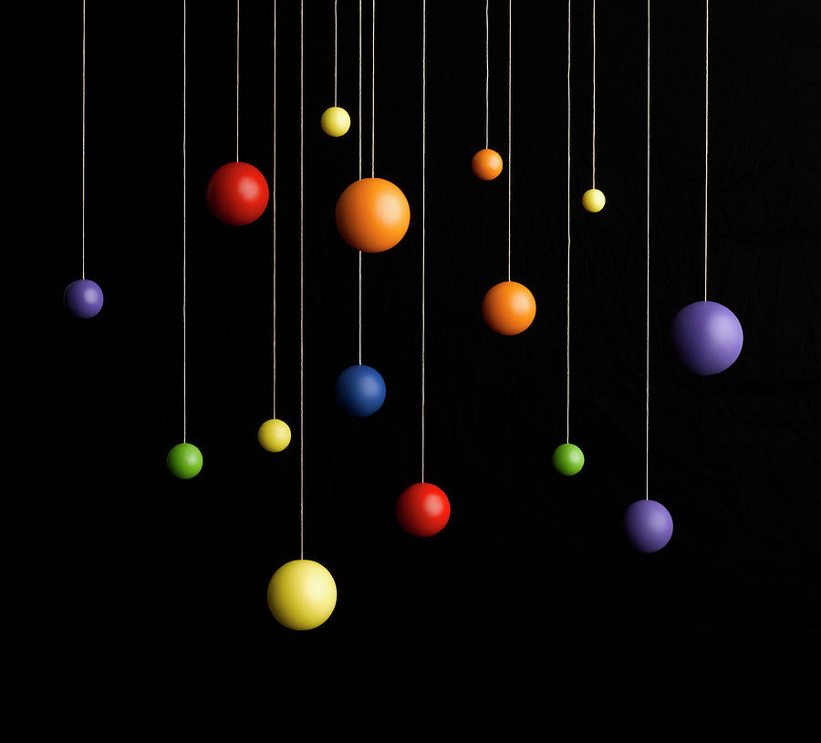Spheres Hanging On Strings Photograph by Jeffrey Coolidge
