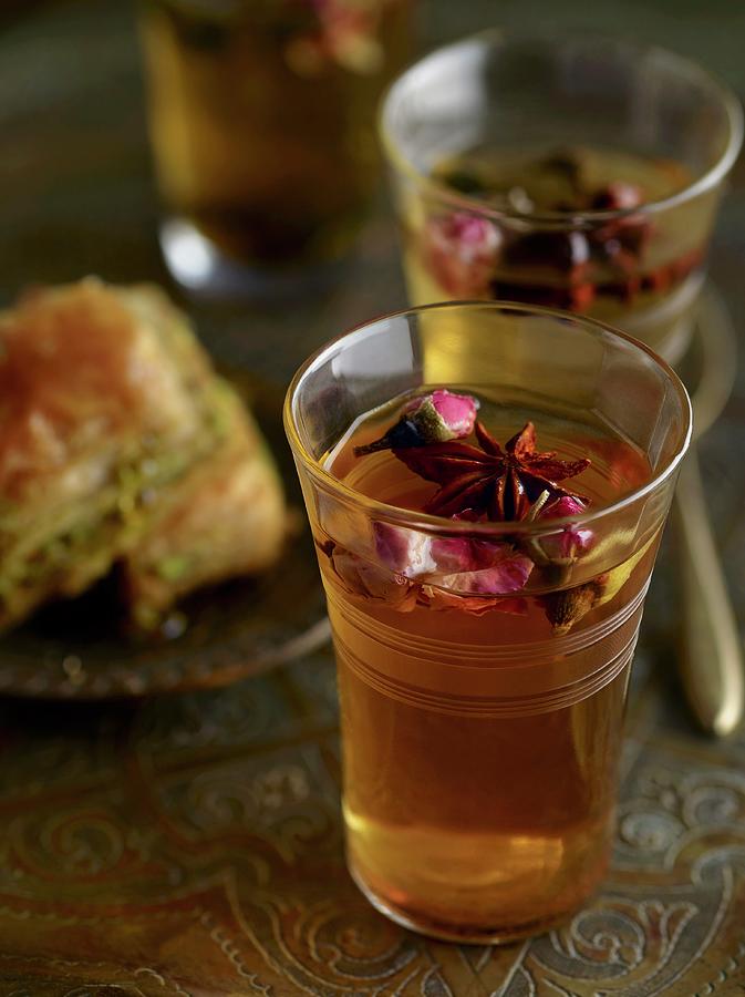 Spiced Tea With Star Anise And Rose Petals And A Baklava In The Background Photograph by Jim Franco Photography