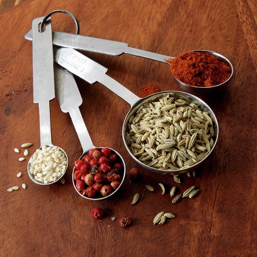 Spices And Sesame Seeds In Measuring Spoons Photograph by Paul Poplis