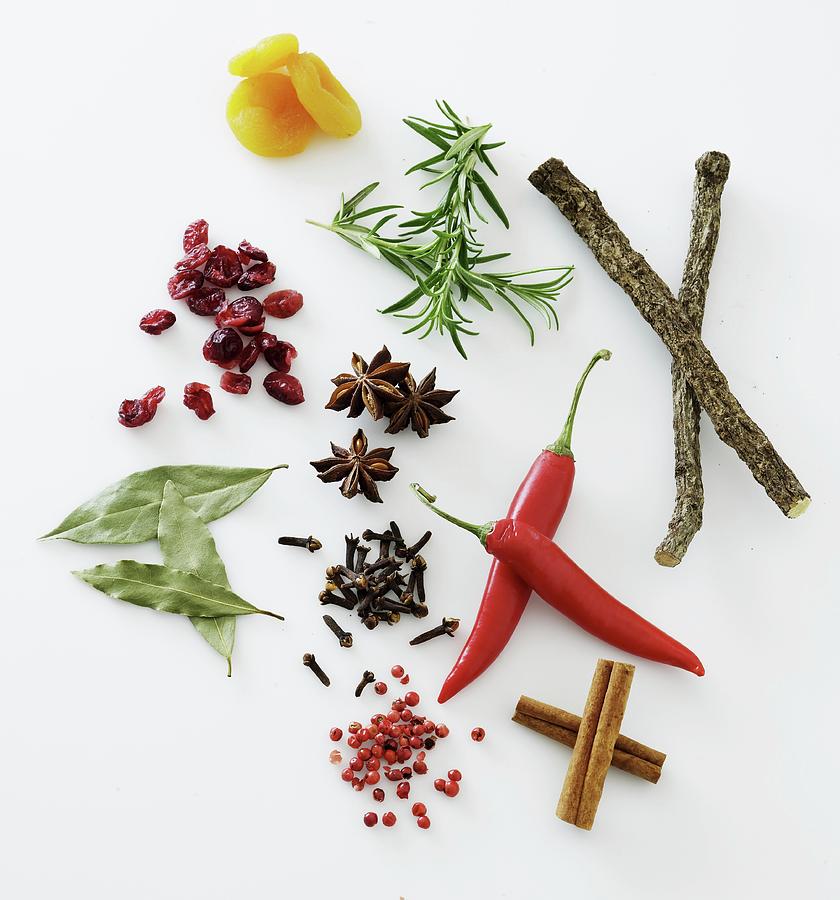 Spices, Herbs And Dried Fruit On A White Surface Photograph by Mikkel Adsbl
