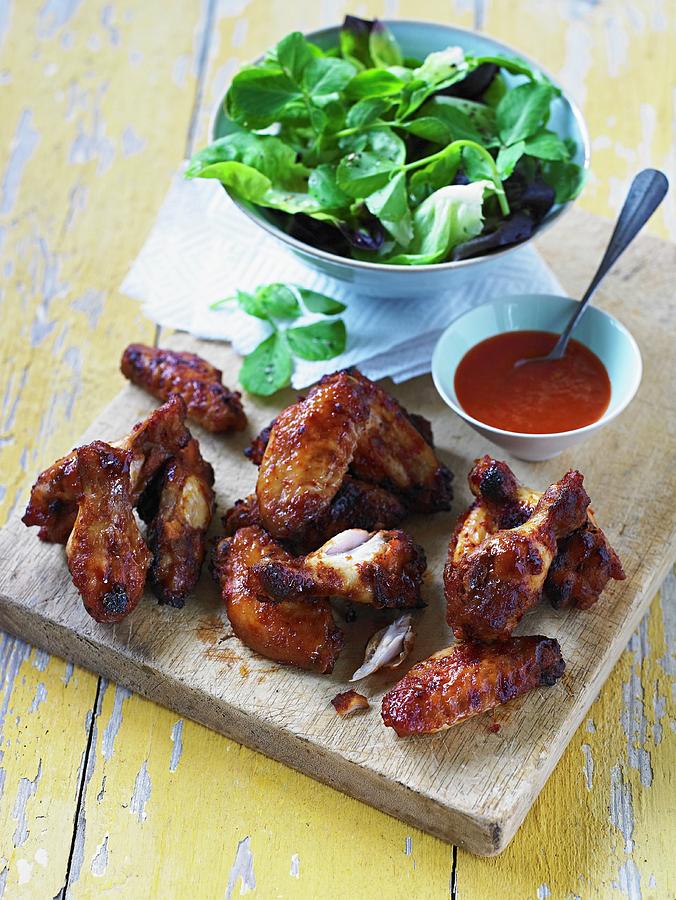 Spicy Chicken Wings With Chipotle, Chilli Sauce And Lettuce Photograph by Clive Streeter