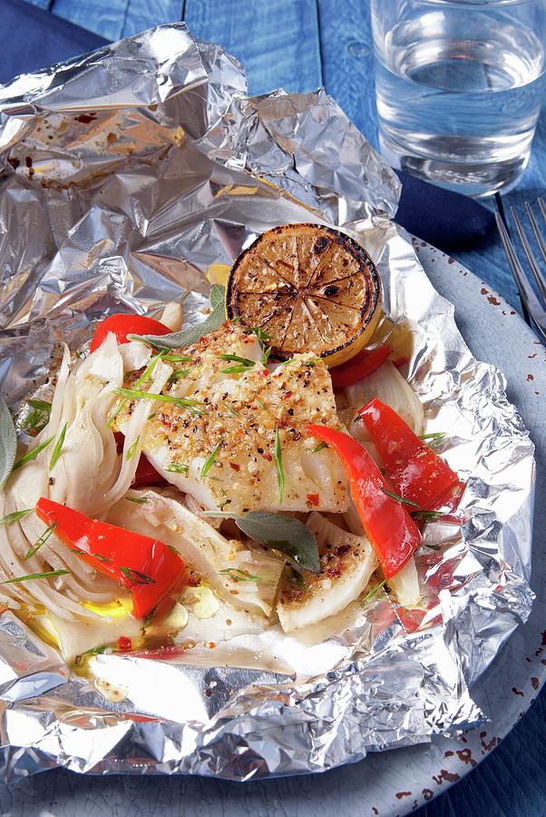 Spicy Cod Fish Cooked In Aluminium Foil Photograph by Spyros Bourboulis