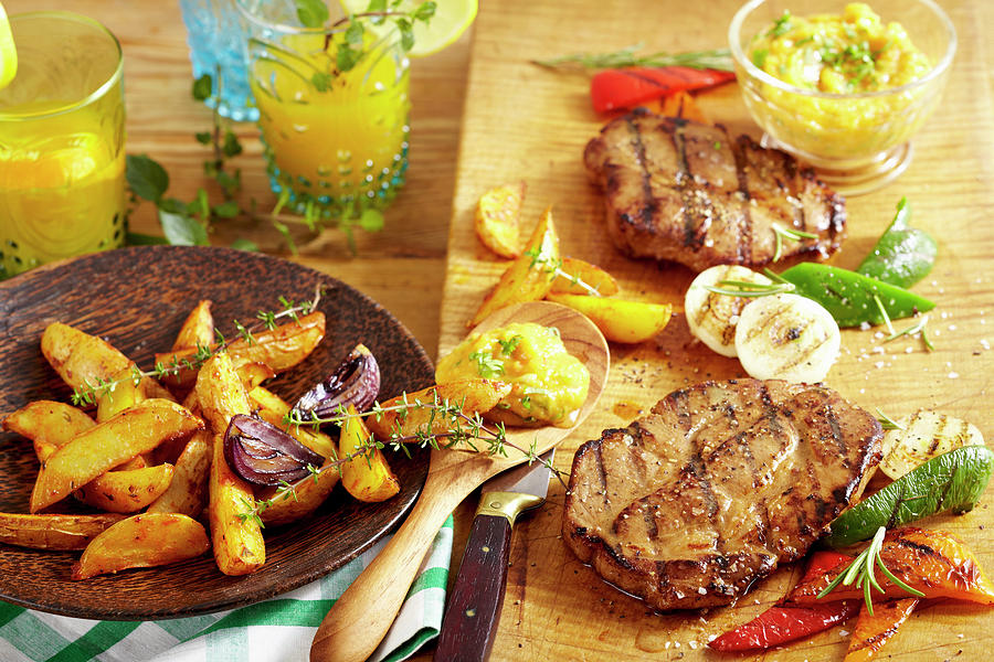Spicy Grilled Pork Collar Steaks With Potato Wedges, Grilled Vegetables And A Mango And Tomato Salsa Photograph by Teubner Foodfoto