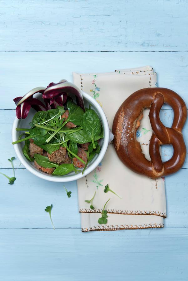 Spinach Salad With Chorizo, Crostini, Cress And Trevisio In A Porcelain Bowl Next To A Pretzel Photograph by Angelika Grossmann